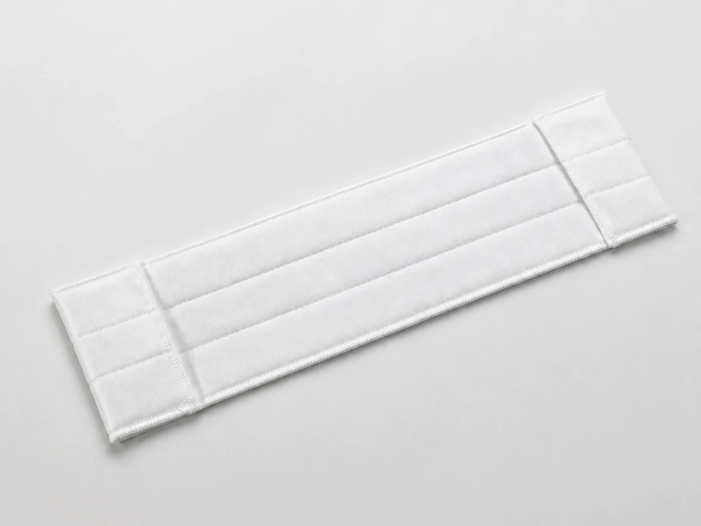 White rectangular cleanroom mop cover with three padded channels and two end pockets